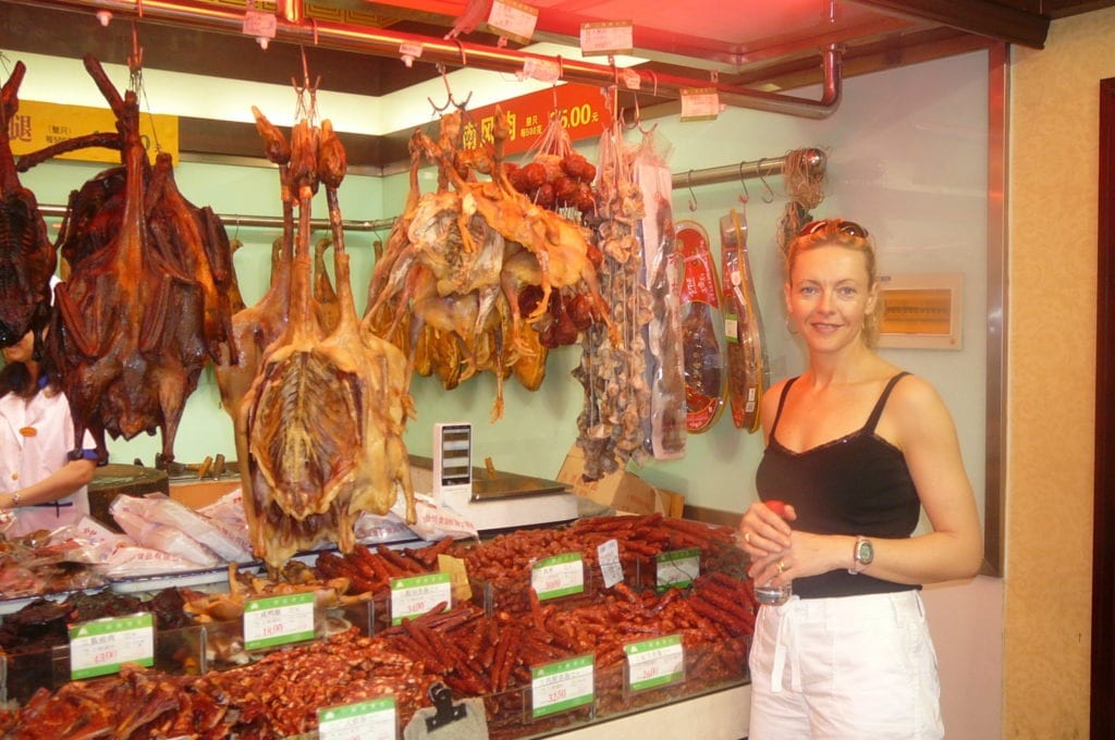 Here's a picture of Nancy checking out authentic Chinese food in Shanghai, China