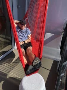 Shawn in his hammock onboard Virgin Voyages' Scarlet Lady