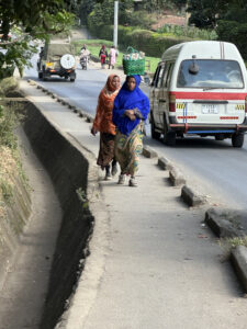 Woman carrying stuff on her head in Arusha, Tanzania