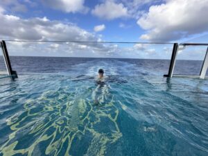 Shawn Power, Your Trusted Cruise, Tauck Tour & Africa Safari Expert in a pool onboard an Explora Journeys Cruise