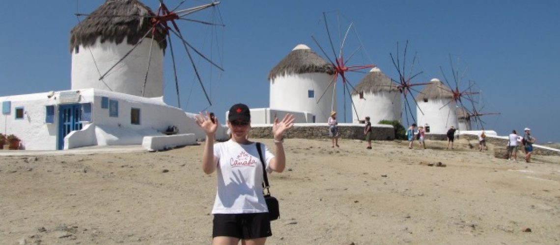 Nancy posing by the famous windmills in Mykonos, Greece